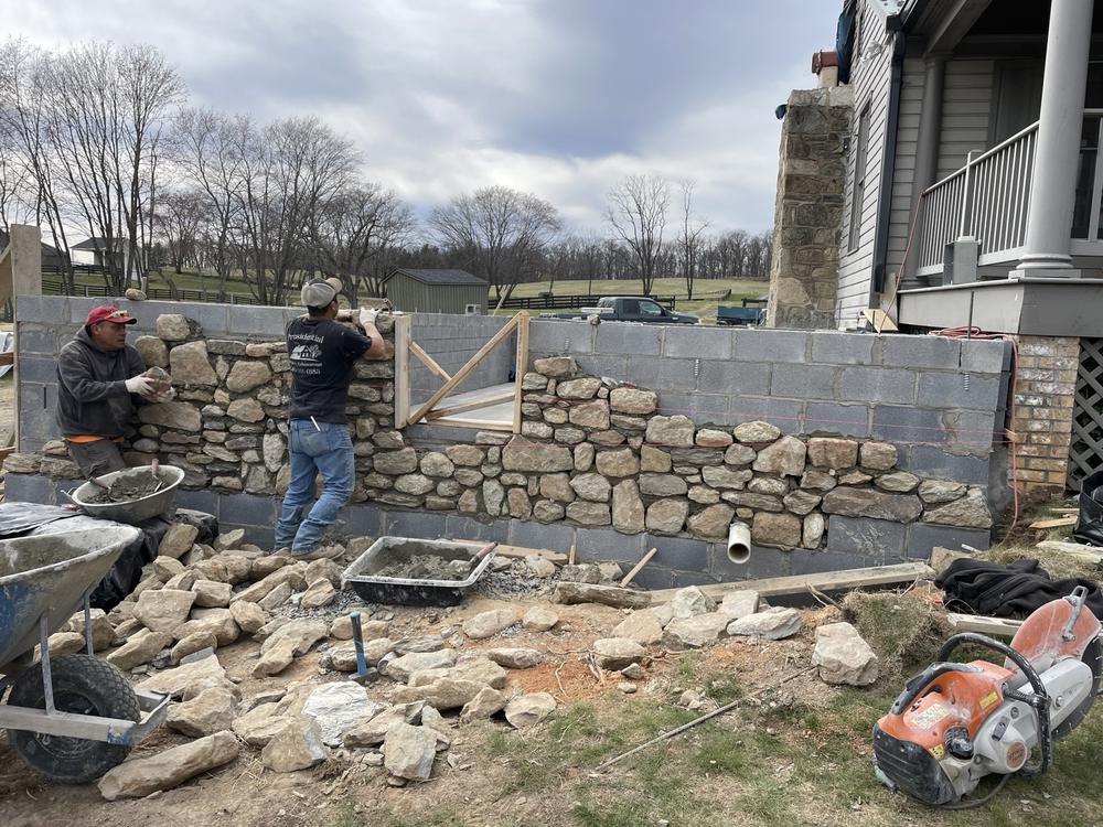 Stone wall being built