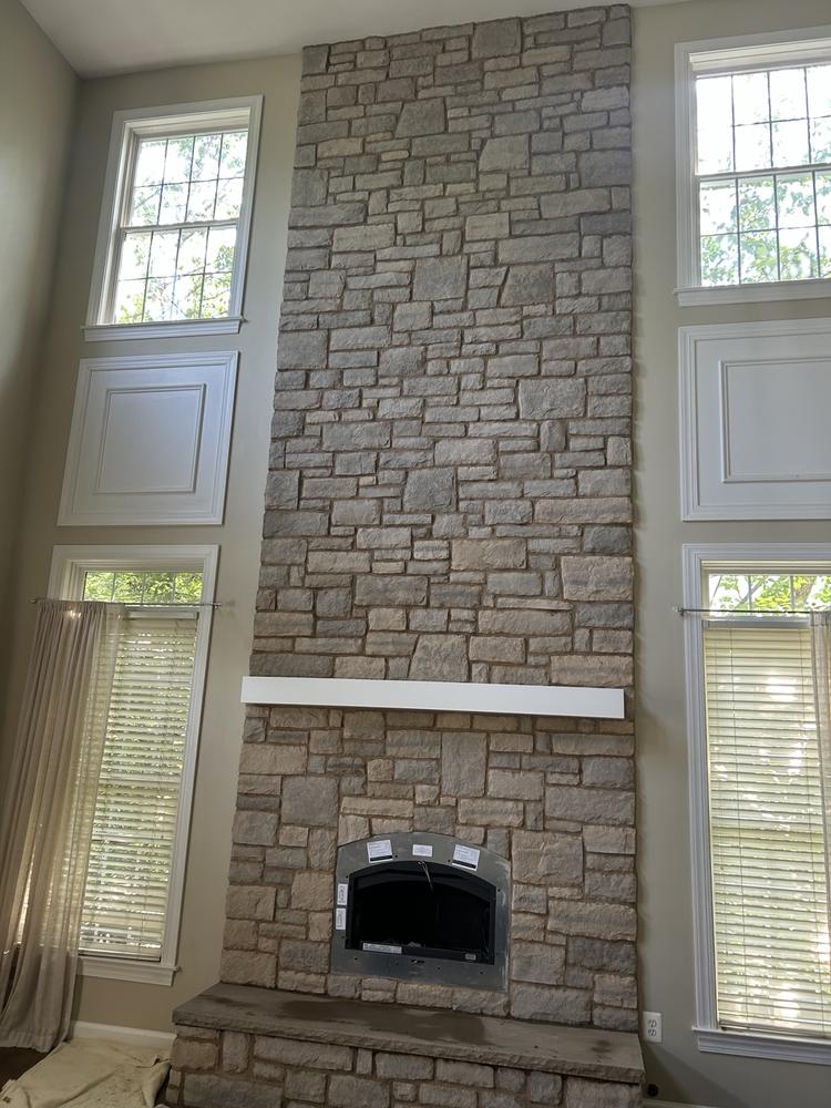 Tall stone fireplace wall